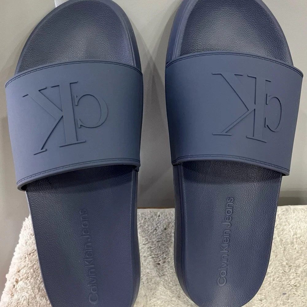 Calvin Klein Medium Gray Embossed CK‎ Slide Sandals